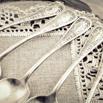 Beautiful silverware on lacy napkin Beautiful antique silverware on lacy napkin